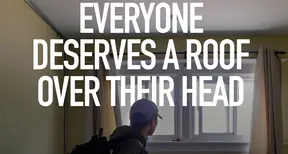 Photo of an individual in a room, with text overlaid that says everyone deserves a roof over their head